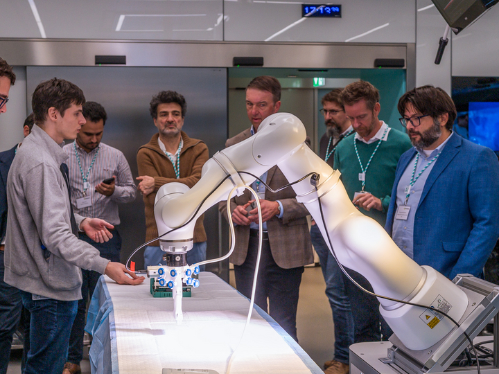 Two engineers showing a group of participants a live robotic demonstration in the OR-X.