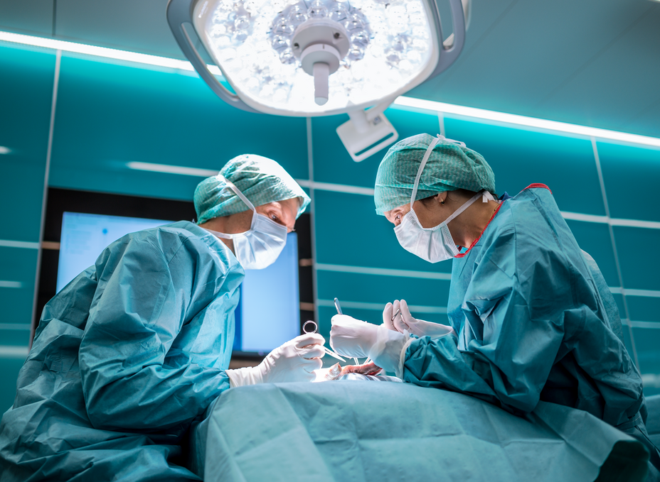 Two residents work on a surgical approach to the hand in the OR-X