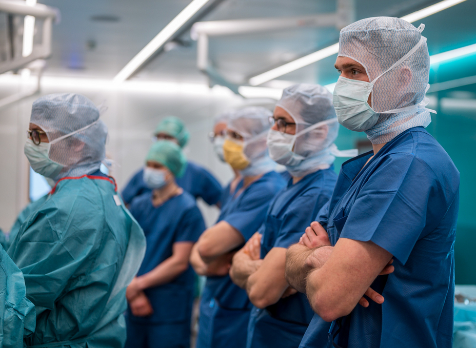 Group of surgeons standing in the OR-X listening to instructions