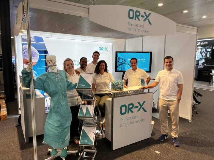 OR-X team of researchers and surgeons standing in front of the booth at Swiss Orthopaedics Congress 2024