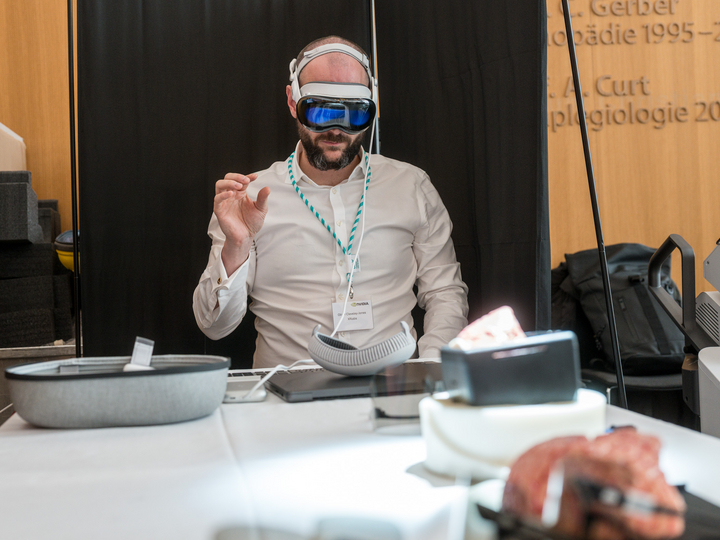 A participant wearing AR glasses for a navigation demonstration in the Balgrist foyer