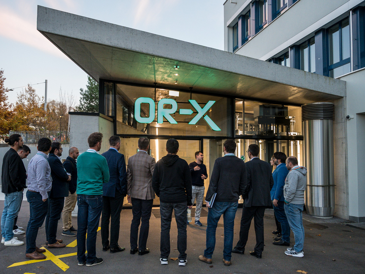 A group of participants standing in front of the OR-X entrance as part of a infrastructure visit.