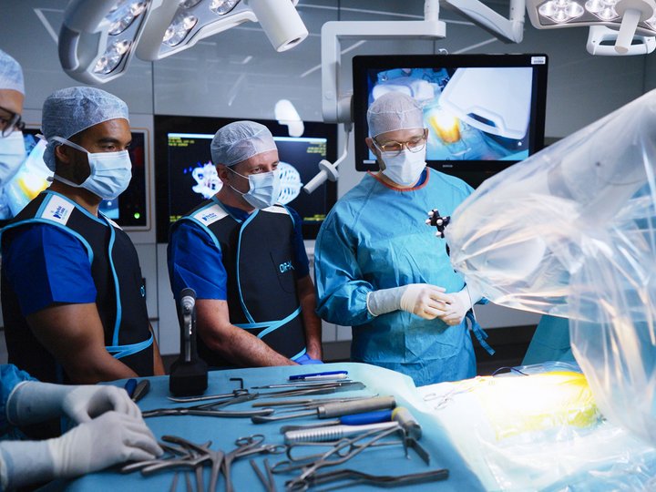 Surgeons and researchers perform a robotic surgery experiment.