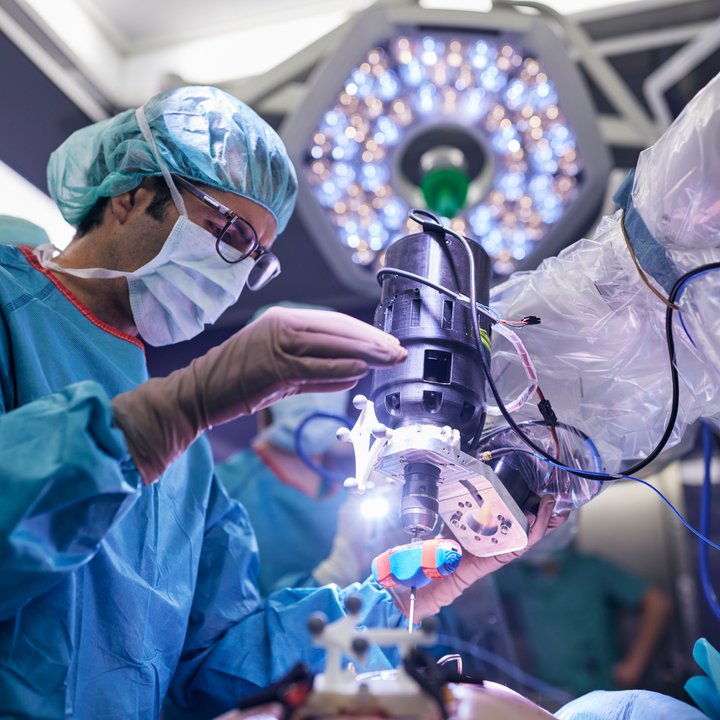 surgeon using high precision robot in a surgical research project.