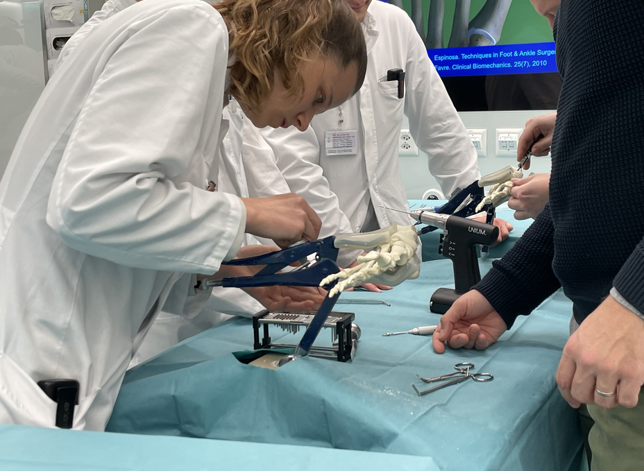 Resident places a screw in the OR-X on an artificial foot model
