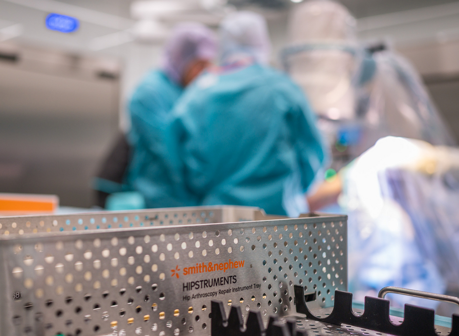 Two surgeons work in the background with an imaging system in the OR-X. In the foreground is an instrument box from Smith+Nephew.