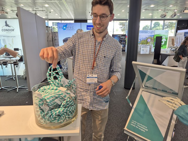 Happy visitor picks an OR-X branded lanyard